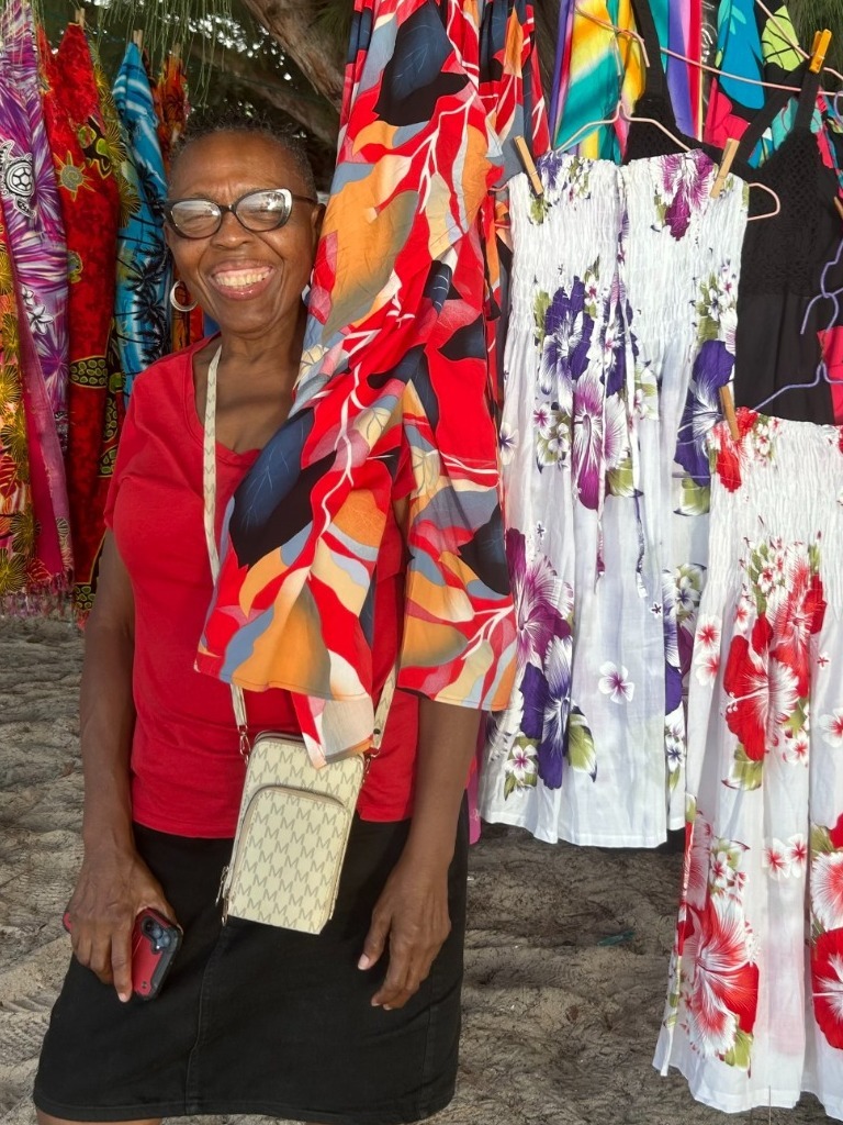 A photorealistic image depicting a group of tourists and locals participating in a traditional Bajan dance workshop on the beach. The instructor is demonstrating the steps, and the participants are enthusiastically following along. The scene conveys a sense of joy and connection. Style: Cultural immersion photography with a focus on capturing the spirit of unity and collaboration. Technical specs: 4K resolution, dynamic composition, vibrant color palette.